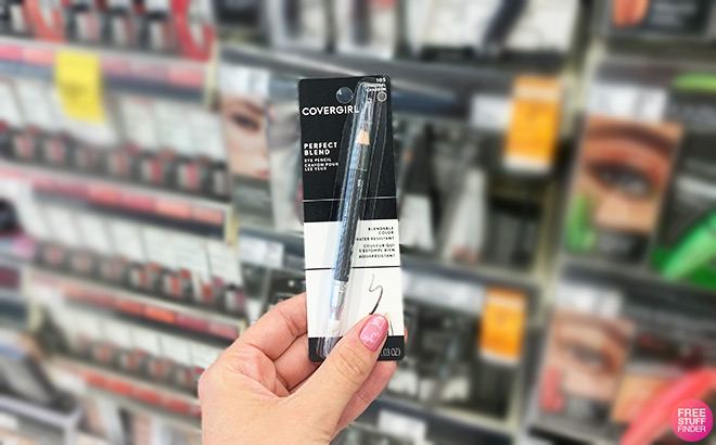 Hand holding Covergirl eye liner in a store aisle