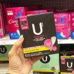 A Person Holding U By Kotex Balance Liners in an Aisle at Walmart