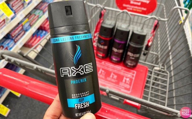 Hand Holding an Axe Body Spray in an Aisle at CVS